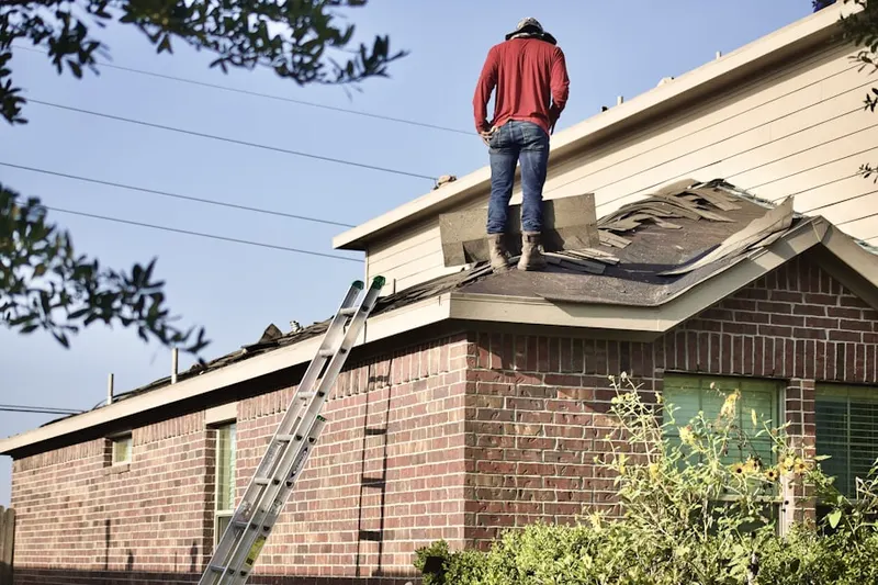 Professional roofer working on a residential roof in Adamston